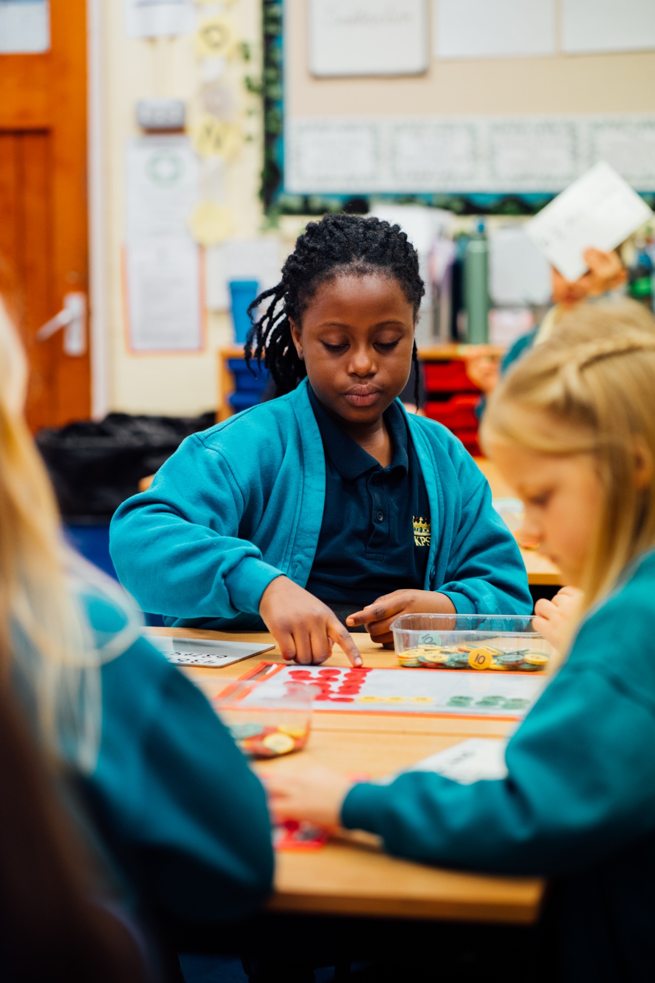 student using counters in maths lesson