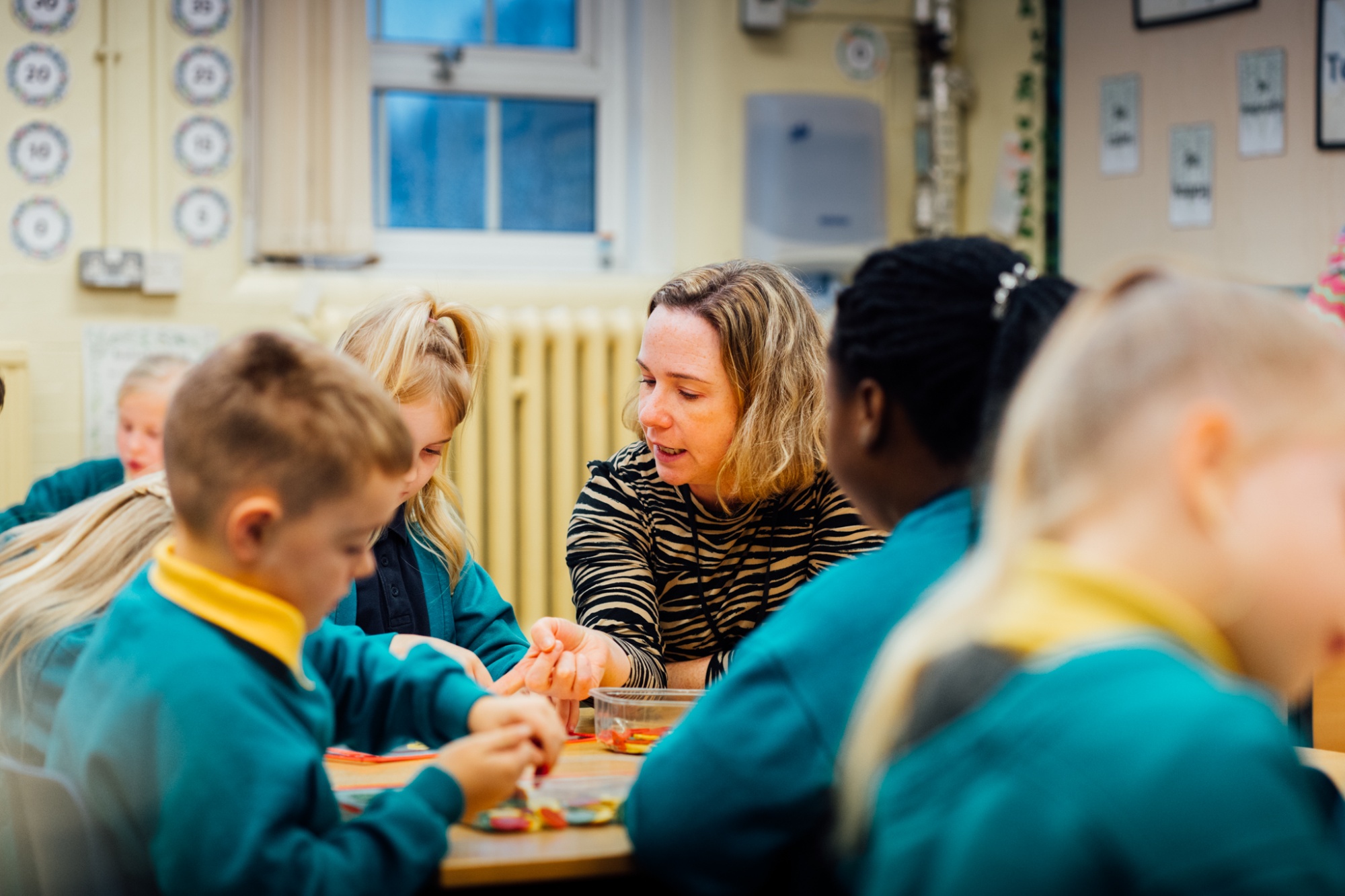 teacher working with students in the classroom