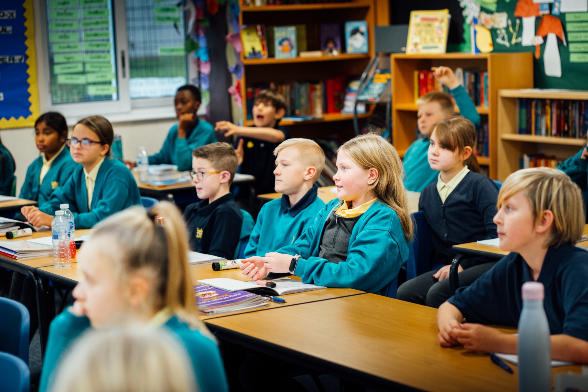 classroom full of students listening to their teacher