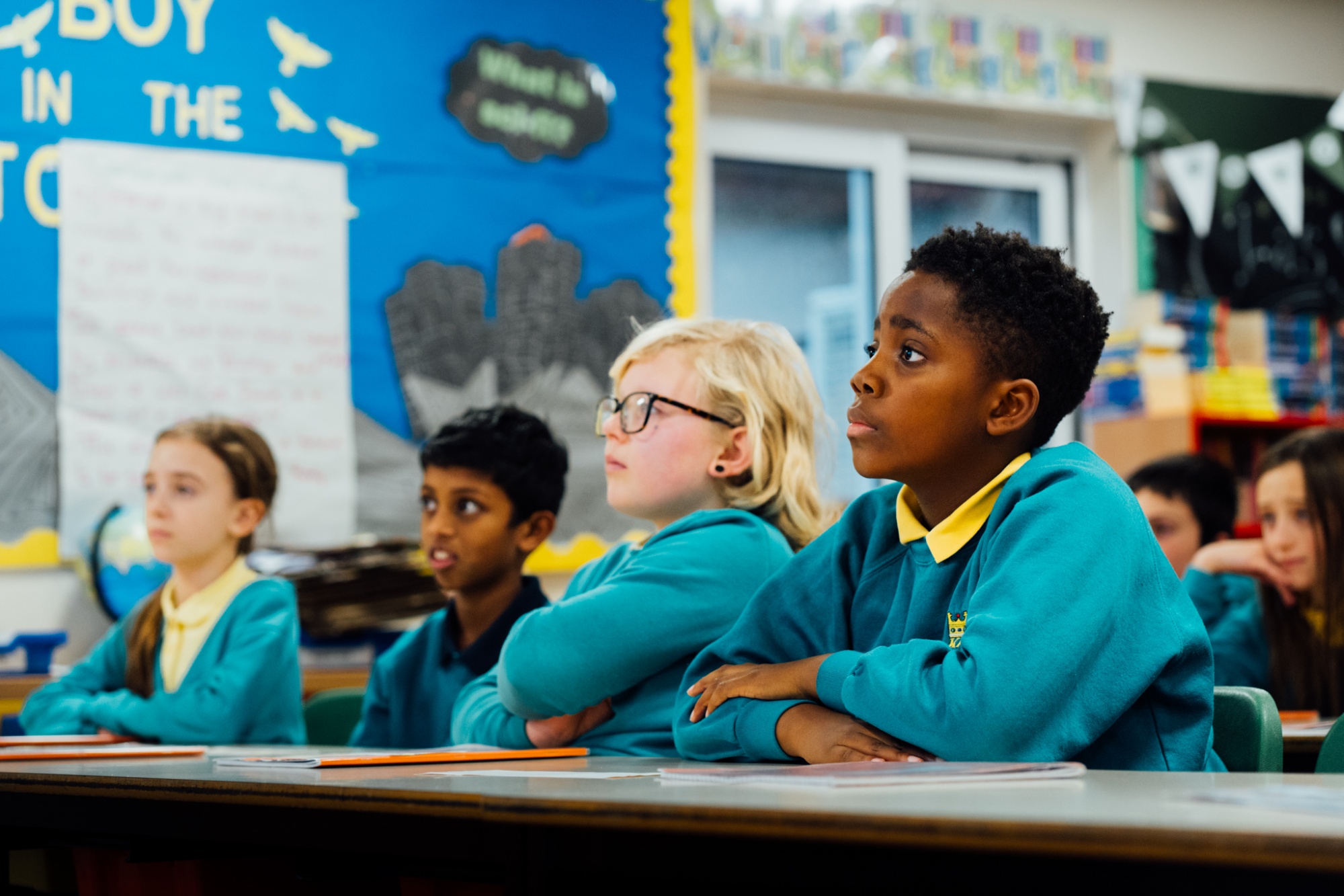 students watching teacher present in class